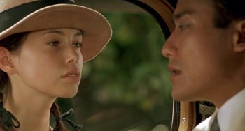 Movie still from “The Lover” (1992), directed by Jean-Jacques Annaud – A man and a woman are looking at one another; Close Up shot, Over the shoulder angle