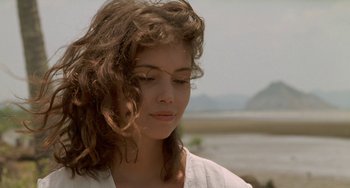 Movie still from “The Lover” (1992), directed by Jean-Jacques Annaud – A person wearing a white shirt; Close Up shot, Over the shoulder angle