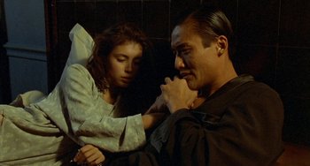 Movie still from “The Lover” (1992), directed by Jean-Jacques Annaud – A man sitting next to a young girl; Close Up shot, Over the shoulder angle