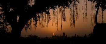 Movie still from “The Lovers” (2015), directed by Roland Joffé – The sun is setting behind a castle in the distance; Extreme Wide shot, Low angle