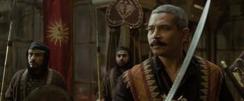 Movie still from “The Lovers” (2015), directed by Roland Joffé – A man with a beard and mustache and a man with a beard and mustache; Close Up shot, Over the shoulder angle