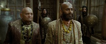 Movie still from “The Lovers” (2015), directed by Roland Joffé – A man with a bald head and a long beard; Medium shot, Low angle