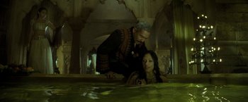 Movie still from “The Lovers” (2015), directed by Roland Joffé – A man and a woman are laying on the ground; Medium shot, High angle