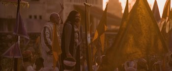 Movie still from “The Lovers” (2015), directed by Roland Joffé – A group of men standing next to each other; Medium shot, Low angle