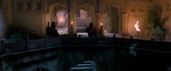 Movie still from “The Lovers” (2015), directed by Roland Joffé – Two people sitting on a bridge with candles lit; Extreme Wide shot, High angle