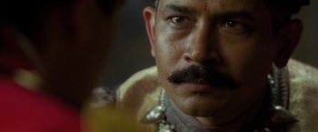 Movie still from “The Lovers” (2015), directed by Roland Joffé – A person with a mustache; Close Up shot, Over the shoulder angle