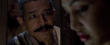 Movie still from “The Lovers” (2015), directed by Roland Joffé – A person with a mustache; Close Up shot, Over the shoulder angle