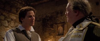 Movie still from “The Lovers” (2015), directed by Roland Joffé – A man and a woman standing next to each other in a room; Close Up shot, Over the shoulder angle