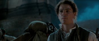 Movie still from “The Lovers” (2015), directed by Roland Joffé – A young man in medieval garb looking into the distance; Close Up shot, Low angle