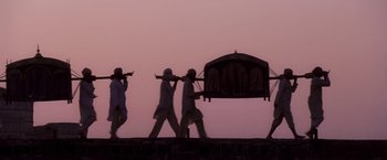 Movie still from “The Lovers” (2015), directed by Roland Joffé – A group of men walking on a wall carrying a cart; Extreme Wide shot, Low angle