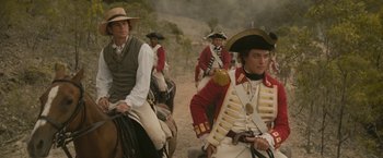 Movie still from “The Lovers” (2015), directed by Roland Joffé – A group of men riding on the backs of horses; Medium shot, Over the shoulder angle