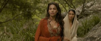Movie still from “The Lovers” (2015), directed by Roland Joffé – A woman in a red dress and a woman in a white veil; Close Up shot, Over the shoulder angle