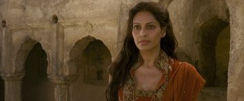 Movie still from “The Lovers” (2015), directed by Roland Joffé – A woman with long black hair wearing an orange dress; Close Up shot, Over the shoulder angle