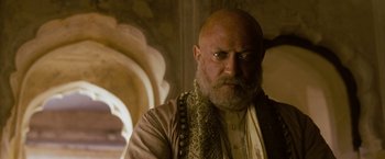 Movie still from “The Lovers” (2015), directed by Roland Joffé – A bald man with a beard and a mustache; Close Up shot, Low angle