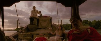 Movie still from “The Lovers” (2015), directed by Roland Joffé – A man and a woman sitting on top of a boat; Wide shot, Low angle