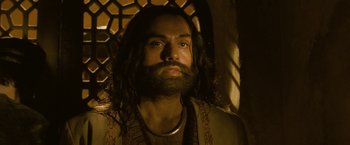 Movie still from “The Lovers” (2015), directed by Roland Joffé – A man with long hair and a long beard; Close Up shot, Low angle