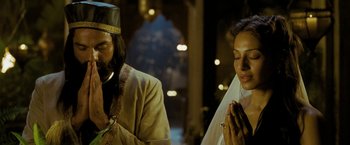 Movie still from “The Lovers” (2015), directed by Roland Joffé – A man and a woman are praying together in front of a window; Medium shot, Low angle