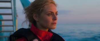Movie still from “The Lovers” (2015), directed by Roland Joffé – A person wearing a jacket near the ocean; Close Up shot, Over the shoulder angle