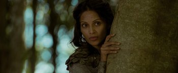 Movie still from “The Lovers” (2015), directed by Roland Joffé – A woman leaning against a tree looking at the camera; Close Up shot, Low angle