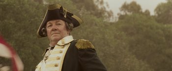 Movie still from “The Lovers” (2015), directed by Roland Joffé – An older man in a military uniform and a hat; Close Up shot, Low angle
