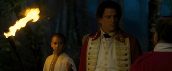 Movie still from “The Lovers” (2015), directed by Roland Joffé – A man and a boy dressed up in costumes; Medium shot, Over the shoulder angle