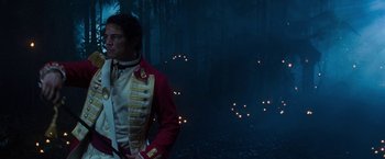 Movie still from “The Lovers” (2015), directed by Roland Joffé – A man in a red jacket standing in the woods; Medium shot, Over the shoulder angle