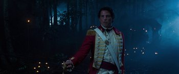 Movie still from “The Lovers” (2015), directed by Roland Joffé – A man in a red and white uniform holding a sword; Medium shot, Low angle