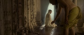Movie still from “The Lovers” (2015), directed by Roland Joffé – A woman sitting on the ground in a room; Wide shot, Low angle