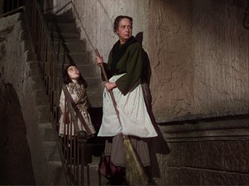 Movie still from “The Loves of Carmen” (1948), directed by Charles Vidor – A woman and a little girl sweeping the stairs; Medium shot, Low angle