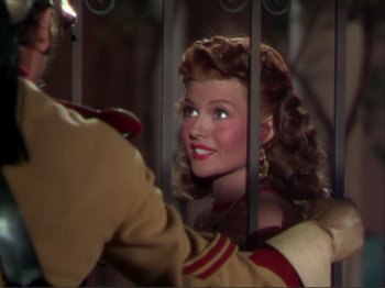 Movie still from “The Loves of Carmen” (1948), directed by Charles Vidor – A woman's face behind bars; Close Up shot, Over the shoulder angle