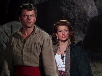 Movie still from “The Loves of Carmen” (1948), directed by Charles Vidor – A man and a woman standing next to each other; Medium shot, Low angle