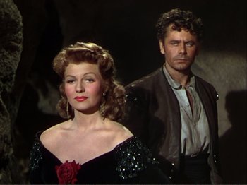 Movie still from “The Loves of Carmen” (1948), directed by Charles Vidor – A man and a woman standing next to each other; Medium shot, Low angle