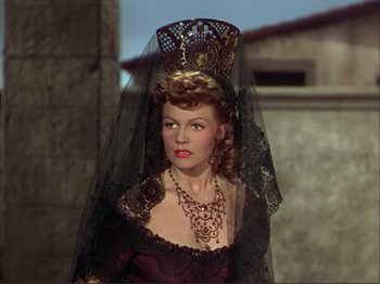 Movie still from “The Loves of Carmen” (1948), directed by Charles Vidor – A woman wearing a black veil and a crown; Close Up shot, Over the shoulder angle