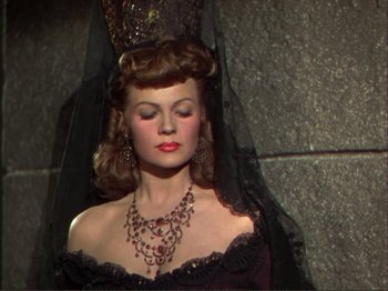 Movie still from “The Loves of Carmen” (1948), directed by Charles Vidor – A woman in a black dress and a black veil; Close Up shot, High angle