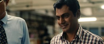 Movie still from “The Lunchbox” (2013), directed by Ritesh Batra – A person wearing a checkered shirt; Close Up shot, Low angle