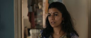 Movie still from “The Lunchbox” (2013), directed by Ritesh Batra – A person wearing a necklace; Close Up shot, Low angle