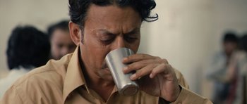 Movie still from “The Lunchbox” (2013), directed by Ritesh Batra – A person drinking a cup of coffee; Close Up shot, High angle