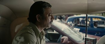 Movie still from “The Lunchbox” (2013), directed by Ritesh Batra – A person sitting in a car on the road; Close Up shot, Over the shoulder angle