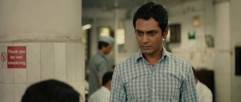 Movie still from “The Lunchbox” (2013), directed by Ritesh Batra – A person wearing a plaid shirt; Close Up shot, Over the shoulder angle