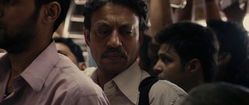 Movie still from “The Lunchbox” (2013), directed by Ritesh Batra – A person wearing a shirt and tie; Close Up shot, Low angle
