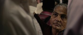 Movie still from “The Lunchbox” (2013), directed by Ritesh Batra – An older man is looking into the distance; Close Up shot, Over the shoulder angle