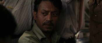 Movie still from “The Lunchbox” (2013), directed by Ritesh Batra – A person wearing a shirt and tie; Close Up shot, Over the shoulder angle