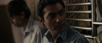 Movie still from “The Lunchbox” (2013), directed by Ritesh Batra – A person wearing a plaid shirt; Close Up shot, Over the shoulder angle