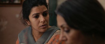 Movie still from “The Lunchbox” (2013), directed by Ritesh Batra – A woman in a sari looking at another woman in an orange sari; Close Up shot, Over the shoulder angle