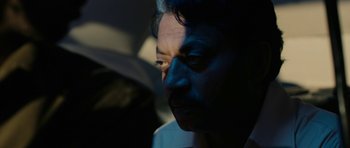 Movie still from “The Lunchbox” (2013), directed by Ritesh Batra – A person's face in the dark; Close Up shot, High angle