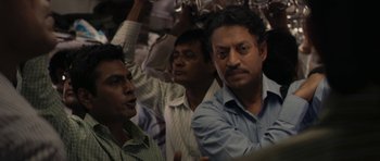 Movie still from “The Lunchbox” (2013), directed by Ritesh Batra – A group of men standing next to each other on top of a train; Medium shot, Low angle
