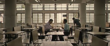 Movie still from “The Lunchbox” (2013), directed by Ritesh Batra – Two men sitting at a table in front of a window; Wide shot, Low angle