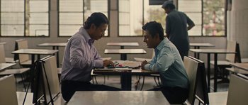 Movie still from “The Lunchbox” (2013), directed by Ritesh Batra – Two men sitting at a table looking at a piece of paper; Medium shot, Over the shoulder angle