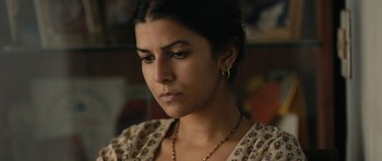 Movie still from “The Lunchbox” (2013), directed by Ritesh Batra – A person wearing a necklace; Close Up shot, High angle