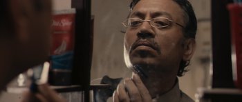 Movie still from “The Lunchbox” (2013), directed by Ritesh Batra – A person holding a razor; Close Up shot, Over the shoulder angle